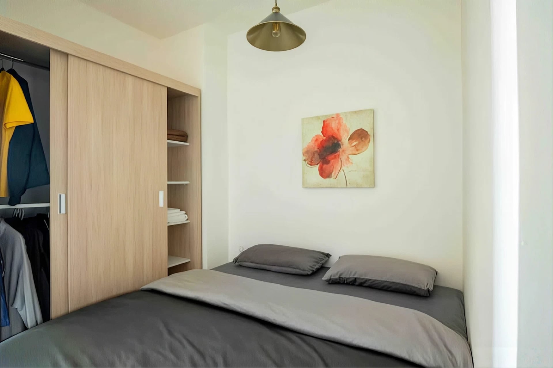 Bedroom with king bed, wardrobe, and pendant light