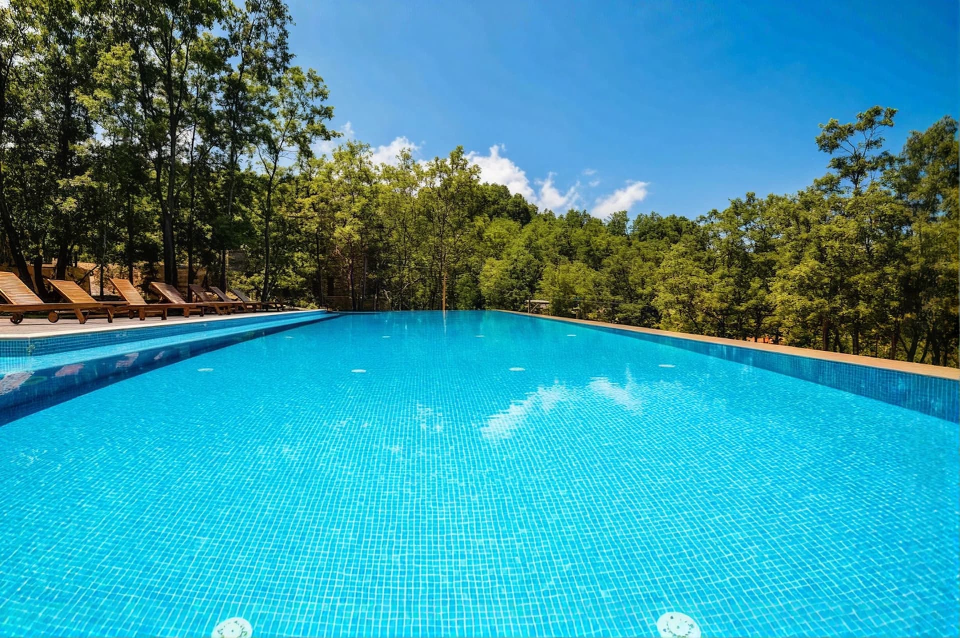 Shared pool and sun loungers at RedRock Faqra