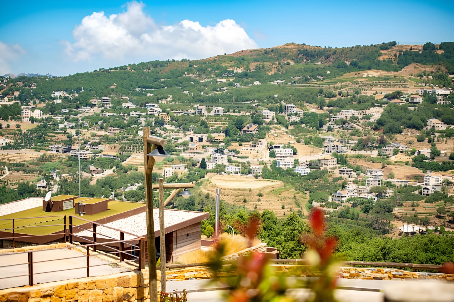 Green valley and village rooftops seen from the terrace