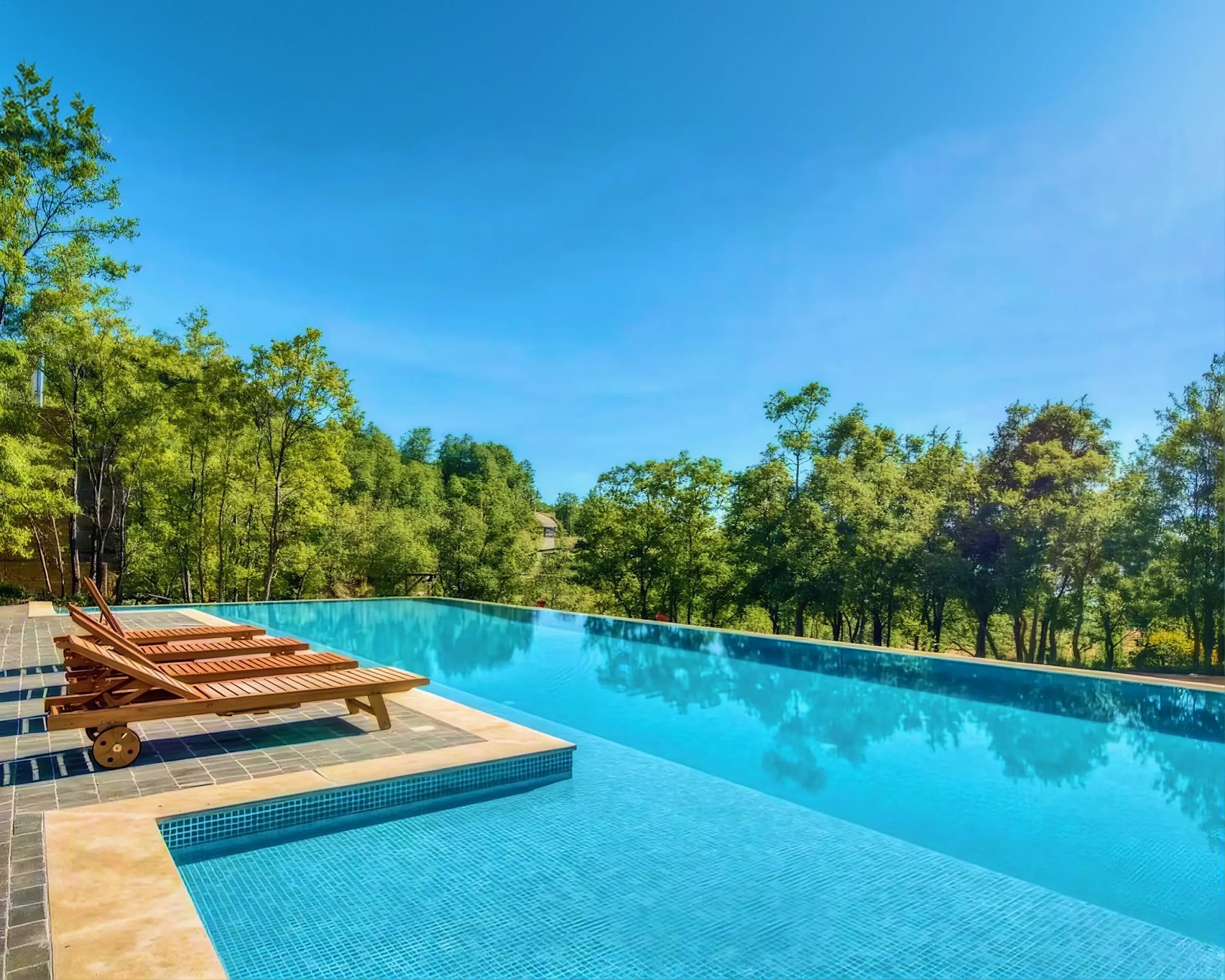 Infinity pool and forest valley at RedRock, Faqra in summer